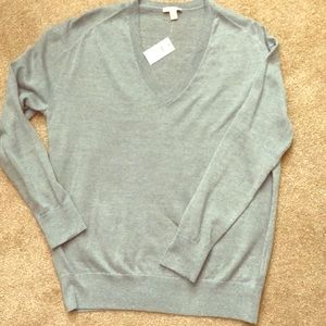 Light blue, V-neck sweater.